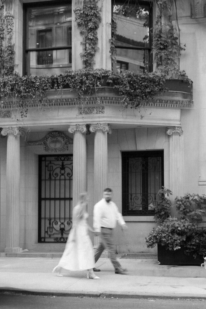 Couple walking through the upper east side for engagement photos