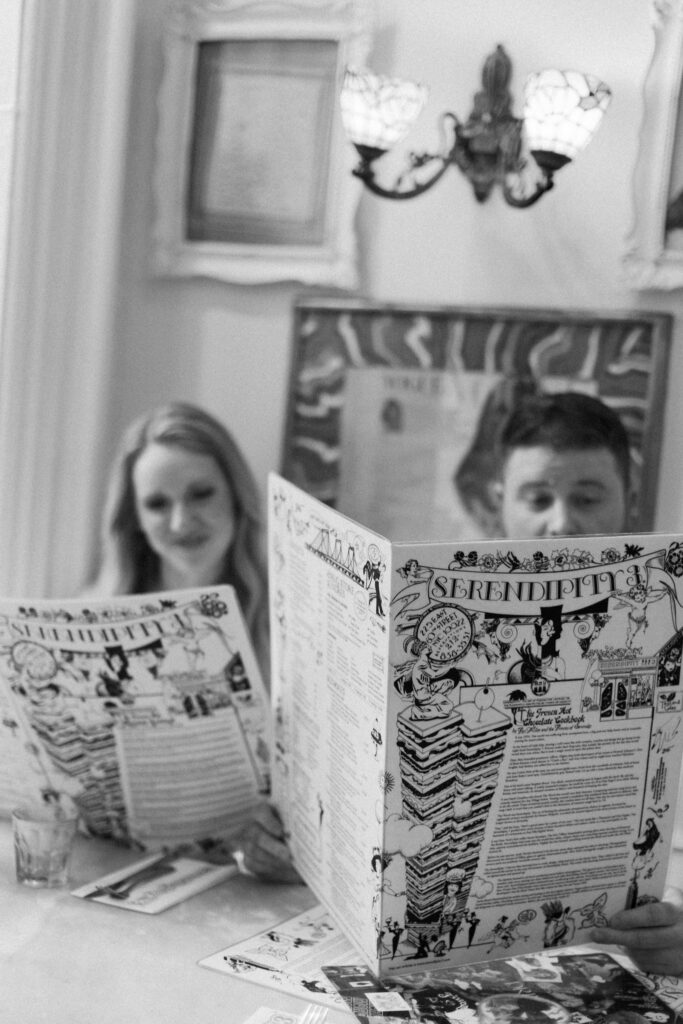 Newly engaged couple sitting at serendipity iii